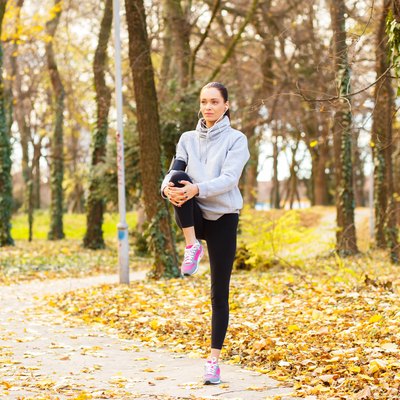 Young woman with headphones preparing for a jogging