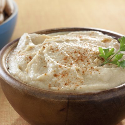 bowl of homemade hummus with breadsticks