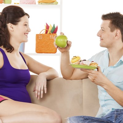 happy expecting parents at home