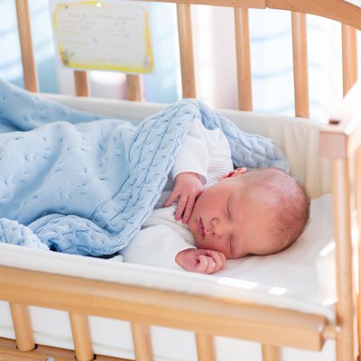 Newborn baby boy in hospital cot