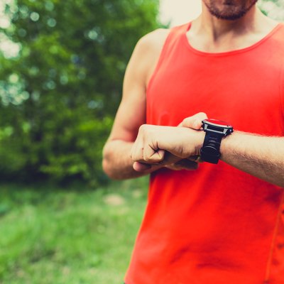Runner looking at sport watch smartwatch