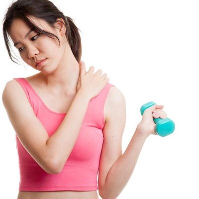 Asian healthy girl got shoulder pain with dumbbell isolated on white background.