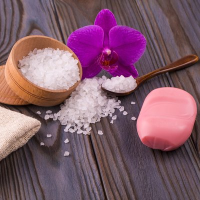 White bath salt in a wooden bowl