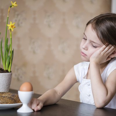 Thoughtful preschooler girl refusing to eat