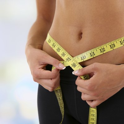Slim girl with centimeter on bright background