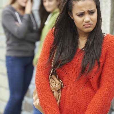 Unhappy Teenage Girl Being Gossiped About By Peers