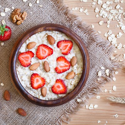 Healthy breakfast oatmeal porridge diet nutririon with strawberry and nuts