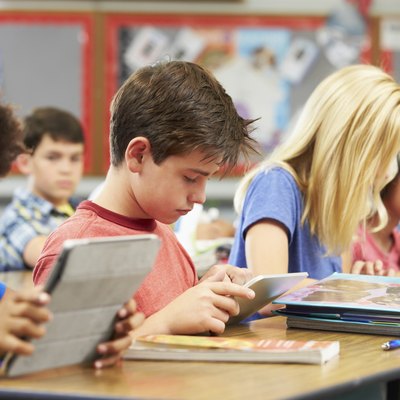 Pupils In Class Using Digital Tablet