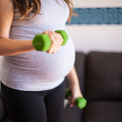 Pregnant woman lifting weights
