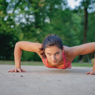 fitness girl doing pushups in park