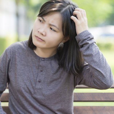Woman Scraching Her Head at Park