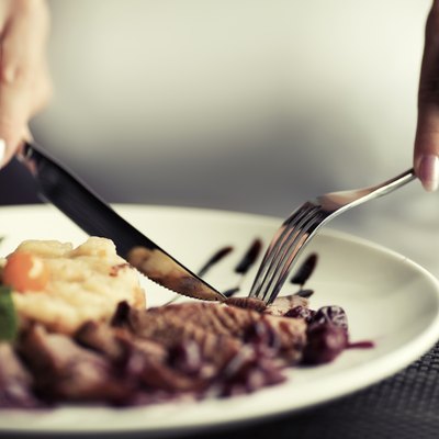 Female hands with a dinner at restaurant