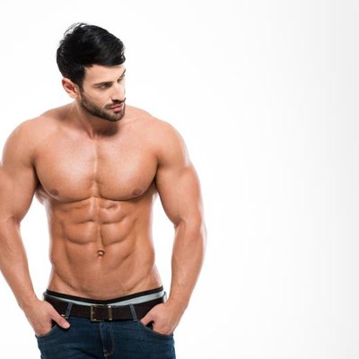 Portrait of a fitness man with nude torso standing isolated on a white background