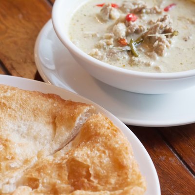 Thai food: green curry with coconut milk and fried Roti