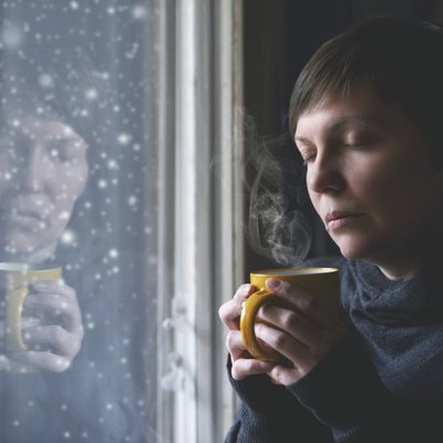 Lonesome Woman Drinking Coffee in Dark Room