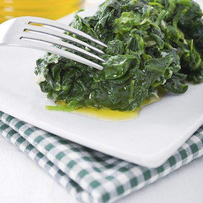Boiled spinach on white dish.