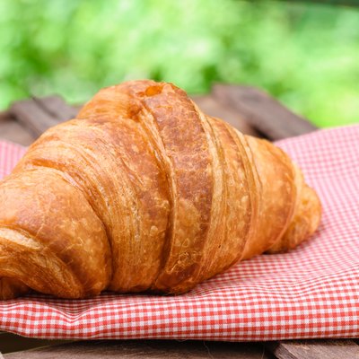 croissant on brown wood table