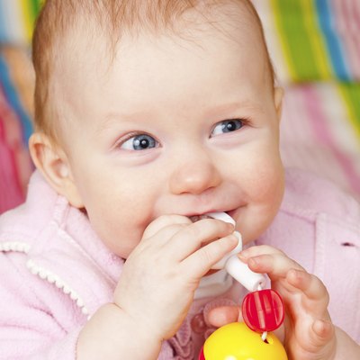 Infant with teething toy