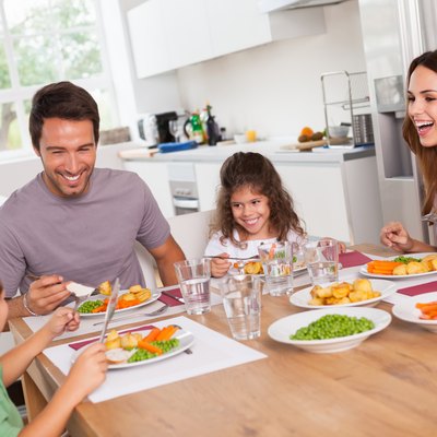 Family laughing around a good meal