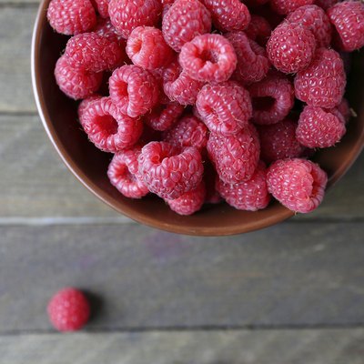 fresh raspberries in a ceramic bowl