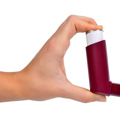 Asthma inhaler in hand