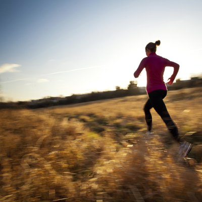 Young woman running outdoors in a city park