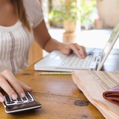 Woman with calculator and laptop