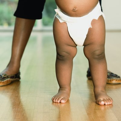 African baby standing with mother