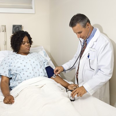Doctor taking patient's blood pressure