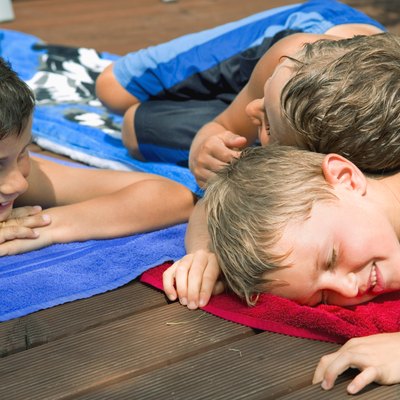 Boys lying on towels