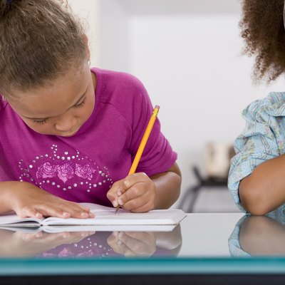 Little girl cheating off classmate