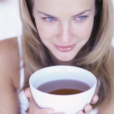 Woman holding cup of tea