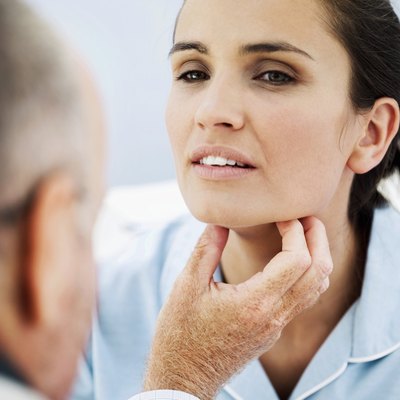 doctor examining a woman's throat
