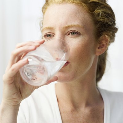 close-up of a woman drinking water from a glass