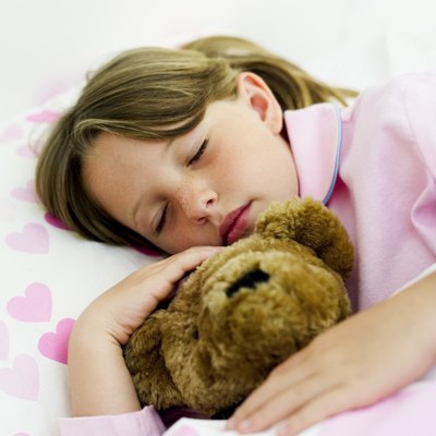 girl (6-7) asleep with teddy bear