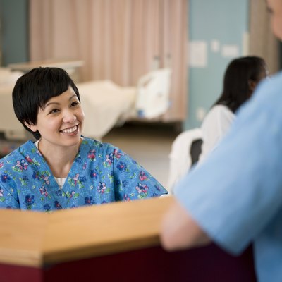 Female nurse and doctor in hospital reception area