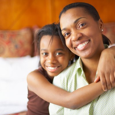 Portrait of mother with daughter in hotel room
