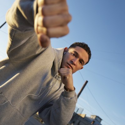 Portrait of man in fighting stance outdoors