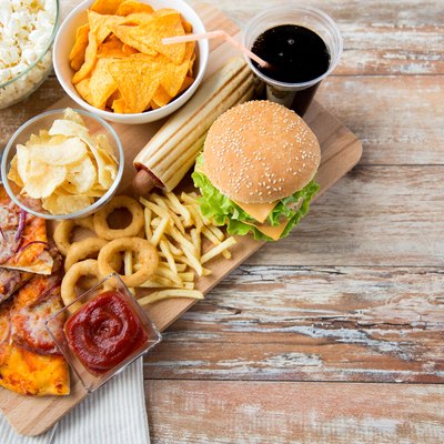 close up of fast food snacks and drink on table