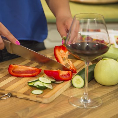 Woman slicing bell pepper for a healthy salad.