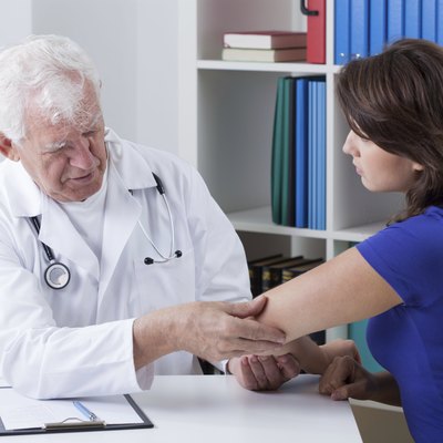 Orthopaedist diagnosing painful elbow