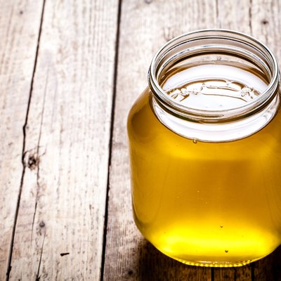 Bowl of honey on wooden table