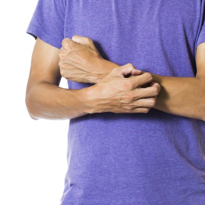 Young man having itchy and dry skin problem