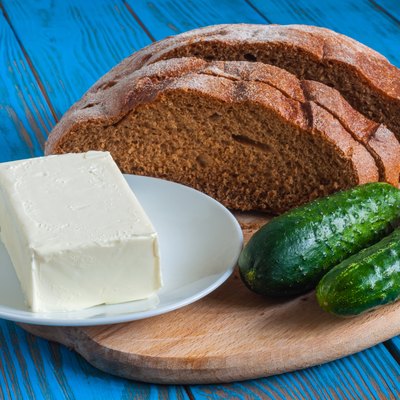 Freshly baked bread, cucumber and butter all for sandwich in