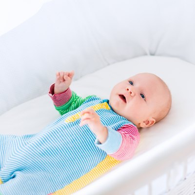Cute baby boy in a white crib