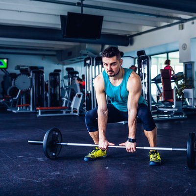 Crossfit instructor at the gym doing Deadlift exercises