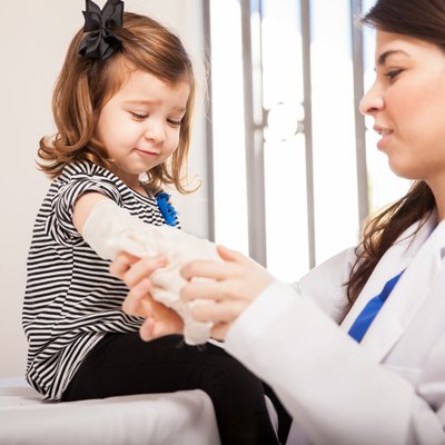 Hurt little girl getting a bandage