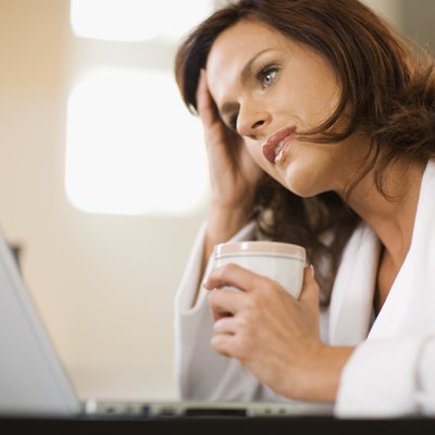 Distraught woman working at home with laptop computer