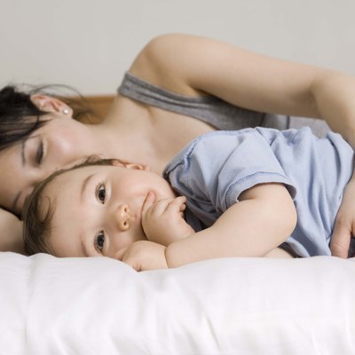 Mother and son lying down on bed