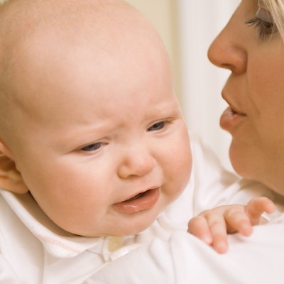 Mother holding upset baby